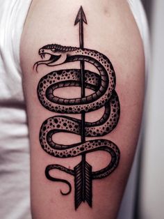 a snake and arrow tattoo on the arm