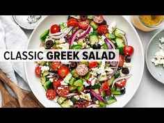 a salad with tomatoes, cucumbers, olives and feta cheese on it