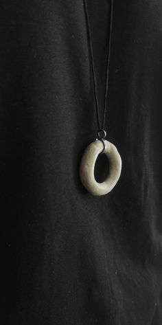 "This concrete  pendant long Necklace is a unique and stunning piece of handmade jewelry that combines modern and artistic style The pendant's shape  is irregular round and open made of  concrete. Τhe pendant is passed on a black synthetic cord,with a handcrafted oxidized silver hook clasp.  A unique and elegant accessory perfect for both casual and formal occasions. In contact with skin, moisture and air, concrete becomes darker. Αs each piece is individually handmade, slight variations in  texture are possible. Handle with care this concrete pendant is somewhat brittle if it falls down on a hard surface it can be damaged. DESCRIPTIONS and MEASUREMENTS: Material:Oxidized sterling silver . Material:Concrete Dimensions concrete: 3,9x3,7 (cm) 1,5x1,46 (in)\" diameter.  length:83,0(cm) 32,67 Modern Handmade Everyday Necklace, Handmade Everyday Circle Necklace, Unique Pendant Long Necklace Gift, Unique Pendant Long Necklace As Gift, Minimalist Handmade Circular Necklace, Modern Handmade Long Necklace, Minimalist Handmade Circle Necklace, Handmade Round Pendant Long Necklace As Gift, Minimalist Handmade Open Circle Jewelry