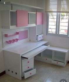 a white desk with pink and grey drawers in a room that has tile flooring