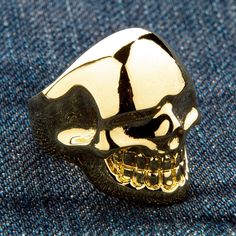 METALIC 14K YELLOW GOLD OVER SOLID BRASS SKULL RING ~NEW  Solid brass with 14k yellow gold plating  Ring weight: 20 grams    Ring face measures: 1" x 1 1/4"   A dash of luxury on every single ride, embrace the decadence of our Metalic Yellow Gold Brass Skull Ring. A combination of gothic design and rich colour, this piece is entirely custom made and truly one-of-a-kind.  The polished skull head sits complete with clenched jaw and deep eye-sockets that glare out at every passer-by. It is only the Luxury Skull Ring With Polished Finish, Luxury Silver Skull Ring With Polished Finish, Luxury Gothic Metal Jewelry, Luxury Gold Skull Jewelry, Luxury Gold Sterling Silver Skull Ring, Luxury Gold Skull Ring Gift, Luxury Unique Gold Skull Ring, Luxury Gold Skull Ring In Sterling Silver, Luxury Gold Men's Skull Ring