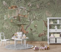 a children's room decorated in green and white with lots of animals on the wall