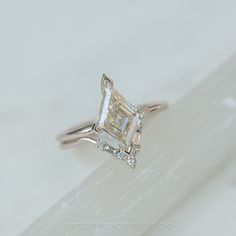 a white gold ring with a princess cut diamond