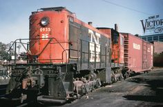 an old red train is sitting on the tracks