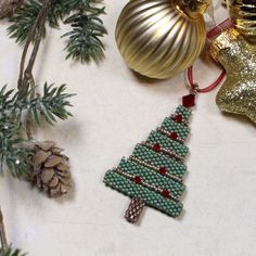 beaded christmas tree ornament next to other ornaments