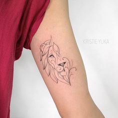 a woman's arm with a lion tattoo on the left side of her body