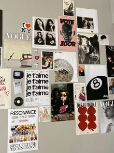 the wall is covered with many different posters and magnets, including one that says i love you