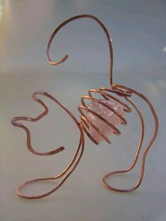 a wire sculpture sitting on top of a table