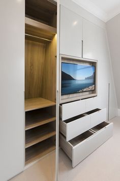 an entertainment center with built - in shelving units and a flat screen tv mounted on the wall