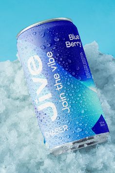 a can of blue berry soda sitting on top of ice