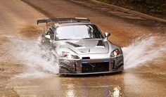 a car is driving through some water on the road