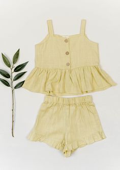 The perfect linen crop top and shorts outfit! Ruffles at hem of tank top and shorts! Functional wood buttons down top. Comes in multiple colors! 30% linen 70% cotton material, ethically sourced. Fit: Runs true to size Crop Top And Shorts Outfit, Buttoned Linen Mini Dress, Fitted Linen Summer Crop Top, Kids Linen Clothes, Fitted Sleeveless Linen Crop Top, Linen Summer Outfits, Linen Summer Dress Kids, Tank Top And Shorts, Linen Crop Top