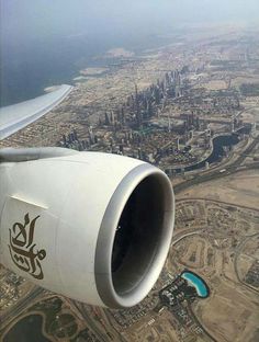 the wing of an airplane flying over a city