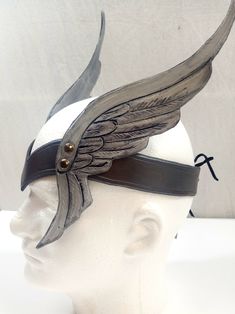 This unique crown features tooled leather wings on each side, making a great valkyrie or fantasy costume accessory. Available in silver or gold tones. Circlet measures 20 inches long and finishes in the back with an eyelet for easy adjustability. Additional styles of crowns and cuffs are also available - take a look at my additional available items! Your leather crown will be shipped first class within three weeks. Steampunk Viking, Valkyrie Costume, Greek God Costume, Winter Cloak, Viking Cosplay, Leather Crown, Diy Wings, Steampunk Hat, Fantasy Costumes