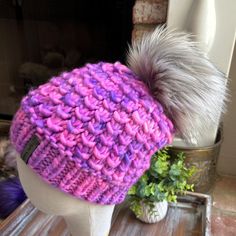 This most wonderful OOAK Erie Beanie has been hand knit by me with hand-dyed yarn from PoconoYarnCo, so you know that absolutely nobody else will ever have this exact same hat in this exact same yarn!  Colorway is "Electric Berry".  Beanie is topped with a luxury faux fur pom. Pom is attached with an engraved pom button for easy on/off. Care instructions: Remove pom & spot clean or hand wash. Roll in towel - do not wring - to remove excess water. Lay flat to air dry. Pattern design by Kelly of KTDesignsOH. You can purchase a digital copy of this pattern through Kelly's Etsy shop. Thank you for supporting my small business! Westlake Village, Faux Fur Pom Pom, Dyed Yarn, Fur Pom Pom, Hand Dyed Yarn, Air Dry, Lay Flat, Hand Knitting, Faux Fur