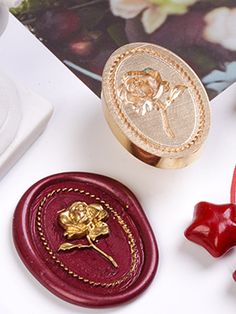 two waxed objects are sitting next to each other on a white surface with flowers