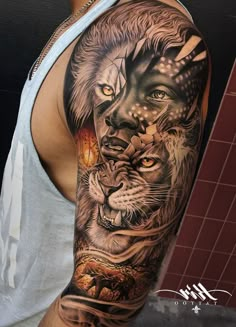 a man's arm with tattoos on it and an image of a lion in the background