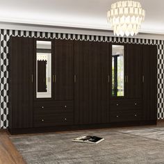 an empty room with black and white wallpaper on the walls, large closets in the middle