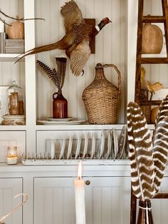 two turkeys are flying in the air above some dishes and vases on a shelf