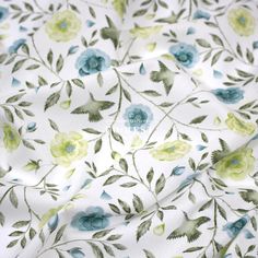 the fabric is white with blue and green flowers on it's side, as well as