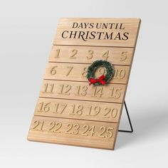 a wooden calendar with a wreath on it