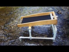 a small wooden step stool sitting on top of a river