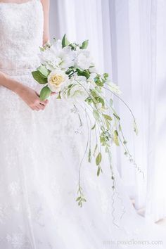 a bride holding a bouquet of flowers in her hand