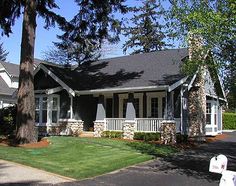 a small house with lots of windows and white trim