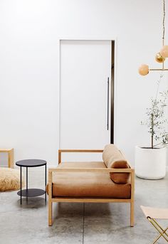 an image of a living room with furniture on the floor and a white wall behind it