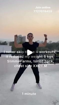 a woman standing on top of a roof with her arms in the air and one hand up