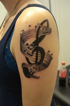 a woman with a musical note tattoo on her arm