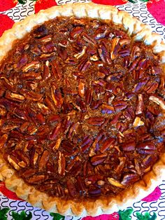 a pecan pie on a colorful table cloth