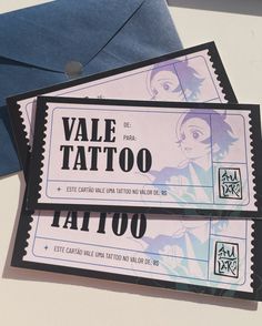 two fake tattoo tickets sitting on top of an envelope next to a blue mailbox