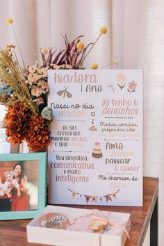 a wooden table topped with pictures and flowers