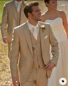 a man in a tan suit and white tie