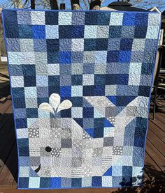 a blue and white quilt with a bird on it