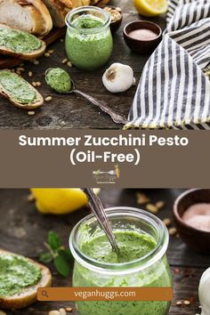 a jar filled with green pesto next to bread and garlic on a wooden table