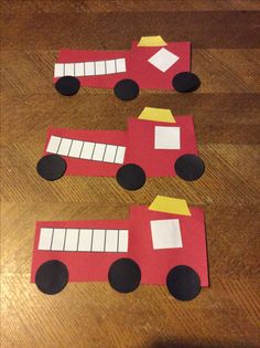 four paper firetrucks cut out to look like they are on the floor