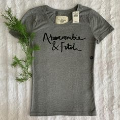 New And Authentic! Size: Small Color: Gray With Black Print A04 Fitted Gray T-shirt For Fall, Fitted Gray Top With Letter Print, Gray Graphic Tee For Fall, Fitted Heather Grey Top For Spring, White Babydoll Top, Pink Floyd Graphic, Queen Tee, Rose Shirts, White Graphic Tee