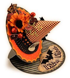 a halloween hat with sunflowers and other decorations on it's side,