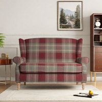 a living room with a plaid couch and bookcase on the wall next to it