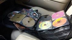 a bunch of cds sitting in the back seat of a car