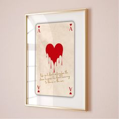 a red heart is dripping from the top of a card in front of a window