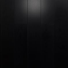 black wood paneling with the light shining on it's side and bottom part