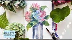 an arrangement of flowers in a blue vase with green leaves and watercolor pencils