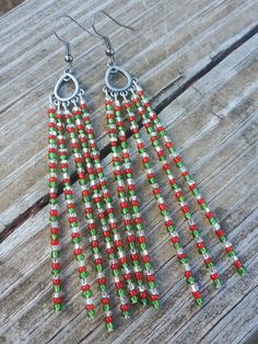 These earrings feature traditional Christmas colored seed beads Christmas Colorful Beaded Dangle Earrings, Christmas Festive Beaded Dangling Earrings, Holiday Beaded Dangle Earrings, Christmas Dangle Beaded Earrings With Colorful Beads, Festive Beaded Earrings With Round Beads, Christmas Dangling Bead Earrings, Christmas Beaded Dangle Earrings With Ear Wire, Christmas Dangle Earrings With Beads, Christmas Dangle Beaded Earrings With Ear Wire