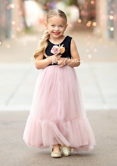 Dress your little one in the enchanting Mauve & Black Tulle Flower Girl Dress to make her feel like a princess at weddings and special occasions! This stunning dress features a delicate black lace bodice combined with a whimsical long flowing mauve ruffle tulle skirt, creating a perfect harmony between elegance and charm. Perfect for dreamy, romantic, fairytale, or classic wedding themes, this dress will surely make your little girl stand out. For an extra touch of magic, pair it with matching b Elegant Bridesmaid Tutu Dress With Lace Trim, Bridesmaid Princess Dress With Lace Bodice, Spring Gown With Lace Bodice In Tulle, Sleeveless Bridesmaid Princess Dress With Lace Trim, Fitted Gown With Lace Bodice For Dress-up, Elegant Pink Tutu Dress For Garden Party, Elegant Tulle Princess Dress For Garden Party, Princess Tulle Bridesmaid Dress, Princess Style Bridesmaid Tulle Dress