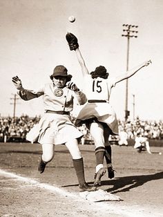 an old black and white photo of two baseball players in mid air during a game