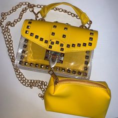 Bright Mustard Yellow Handbag With Gold Accents. Half Bag Is Plastic See Through And A Flip Over Pouch With Gold Lock. Includes A Removable Yellow Pouch In Bag. Comes With 14in Gold Shoulder Carrying Chain. Chic Yellow Pouch Satchel, Yellow Crossbody Satchel For Summer, Trendy Yellow Crossbody Bag, Yellow Pouch Satchel With Detachable Strap, Trendy Yellow Crossbody Satchel, Trendy Yellow Satchel With Adjustable Strap, Trendy Yellow Shoulder Bag With Detachable Strap, Trendy Yellow Crossbody Shoulder Bag, Trendy Yellow Tote Bag