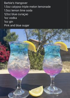 two glasses filled with liquid and lemon wedges